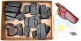 lot of assorted holsters and grips to include