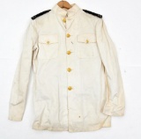 WWII U.S. Navy Officers dress whites, tunic & pants. Showing assorted storage and handling wear....