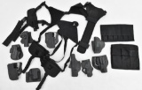 Large lot of assorted Kydex paddle and belt holsters along with shoulder rigs, etc