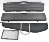 Lot of three long gun cases, two of which are hard sided and padded along with a glass display