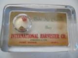 EARLY INTERNATIONAL HARVESTER ADVERTISING PAPER WEIGHT WITH A SMALL PAIR OF DICE-FT. DODGE IOWA