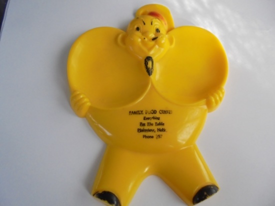 VINTAGE HARD PLASTIC SPOON REST WITH ADVERTISING FROM "FAMILY FOOD CENTER" OF PLAINVIEW NEBRASKA