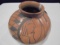 4 3/4 INCH TALL TAN POTTERY POT WITH DECORATED BOTTOM