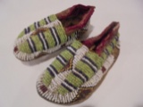 4 1/4 INCH LONG PAIR OF CHILD'S MOCCASINS WITH GREEN AND WHITE BEADWORK