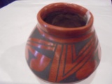 4 1/2 INCH POT WITH BLACK DESIGN ON RED- IT IS SIGNED, BUT HARD TO READ