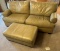 TAN LEATHER COUCH WITH MATCHING OTTOMAN.