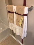 Contents of bathroom, towels, metal wall decor