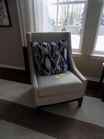 Upholstered chair with nail-head trim