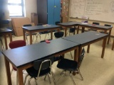 Nine student tables and 19 chairs. Contents not included