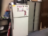 General Electric refrigerator and metal cabinet. Contents not included