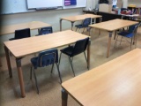 Seven tables and 11 student chairs.