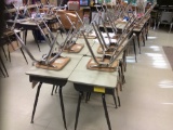 24 desks and 24 chairs.
