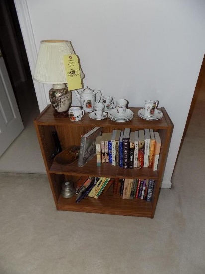 Modern bookcase, oriental lamp, books, and child's tea set