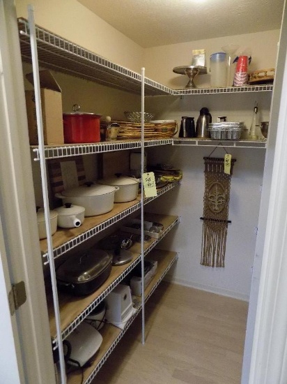 Closet of kitchen appliances, serving items, vases, cookie cutters, grinder, and enameled pots