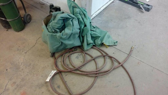 Welding coats, mop buckets and air hose.