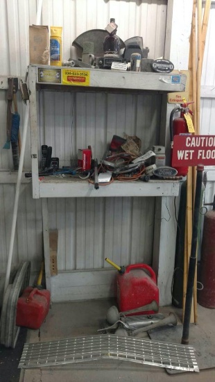 Misc car parts, wet floor sign and gas cans.