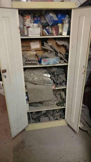 Metal cabinet and assorted car parts.