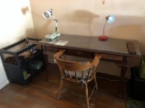 Desk with glass top, lamps, chair and side table.