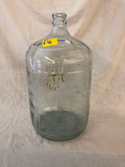 5-gallon glass jug with advertisement