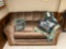 Global Furniture loveseat with golfing pillows, afghan