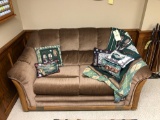 Global Furniture loveseat with golfing pillows, afghan