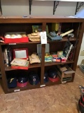Shelf with contents including tanks, baseballs, helmets and toys.