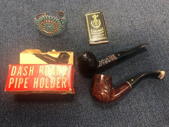 Two vintage pipes, a dashboard pipe holder, and bracelet with turquoise