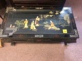 Very ornate carved and inlay oriental coffee table with glass top