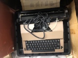 Sears typewriter, slide projector and a desk lamp