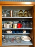 Cupboard full of dishes, measuring cups