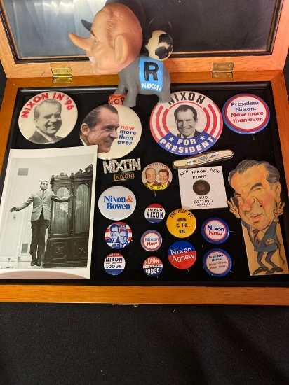 Nixon political pins, pocket knife, rubber doll, etc. with glass display case.