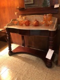 Marble-top stand with splash back and drawer.