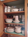 Contents of kitchen cabinet including glass basket, meat grinder, tumblers, dish set, flatware