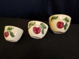 Graduated set of apple painted ovenware bowls