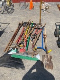 Assorted lawn tools, rakes, shovels, brooms, limb loppers