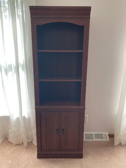 Approximately 6' tall bookcase with 2 doors at bottom