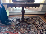 Antique swivel top walnut pedestal game table