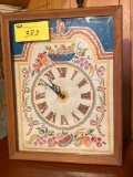 Needlepoint faced electric clock.