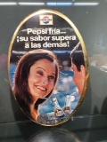 Metal Pepsi advertising sign in Spanish