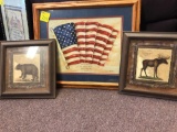 Framed artwork including flag, moose, bear