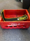 Two plastic Coca-Cola crates and Wild Turkey bar mat