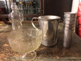 Aluminum ware pitcher and cups, glass bottle guy, dish