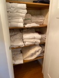 Contents of hallway closet including towels and blankets