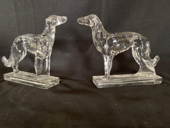 Pair solid glass dogs, 7" tall x 9.5" long.