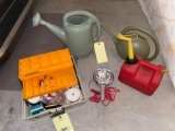 Fish tackle box, (2) water sprinkling cans, light beam, gas can.