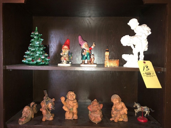 Shelf contents, troll carvings, Goebel gnomes, small ceramic Christmas tree