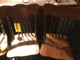 Four oak pressed back bar stools
