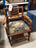 Ornate arm chair on casters