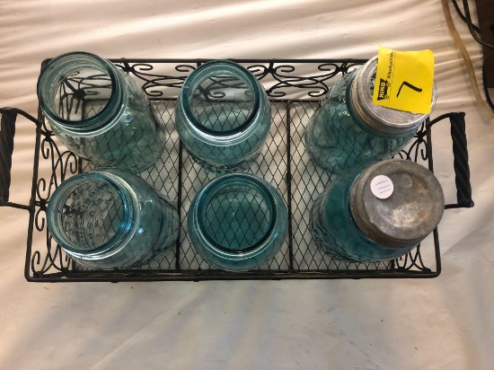Vintage green glass quart size mason jars in metal carrier