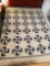 Handmade quilt blue and white pattern, has large stain